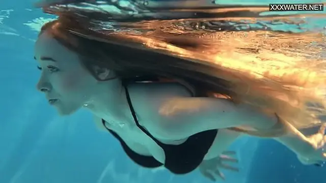 Perfect body blonde teen enjoys naked swimming